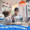A father and daughter are looking at a small aquarium on a table in a bright, modern kitchen. Náhľad obrázku produktu
