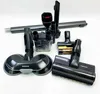 A collection of vacuum cleaner attachments and accessories laid out on a white surface. Anteprima dell’immagine prodotto