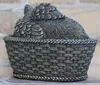 A close-up view of the back of a cat urn shaped like an angel, resting in a woven basket. Anteprima dell’immagine prodotto