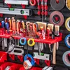 A well-organized tool board with various tools and accessories mounted on a dark pegboard. Náhled obrázku produktu