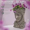 A decorative plant pot shaped like a woman's upper body, filled with purple flowers and green leaves, set against a gradient background. Náhled obrázku produktu