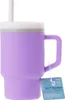 A purple Infantino My 1st Tumbler with a white straw and lid, shown against a white background. A product tag is attached to the handle. Produktbild-Vorschau