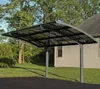 A carport structure is shown in a residential setting, attached to a house, with a lawn and trees in the background. Podgląd zdjęcia produktu