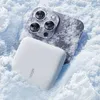 A smartphone and a power bank are partially covered in snow. Náhľad obrázku produktu