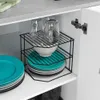 A kitchen cabinet interior with dishes and glasses stored on a shelf organizer. Náhled obrázku produktu