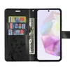 A black wallet-style phone case is open, showing credit cards and cash inside, with a smartphone placed in the right compartment. Produktbild-Vorschau