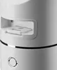 Close-up of a white electronic device with a small white card inserted into a slot. Náhled obrázku produktu