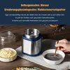 A coffee grinder is shown on a wooden table, with bowls of ingredients and a hand stirring a dark paste. Produktbild-Vorschau