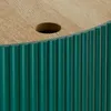 A close-up view of the top and side of a green fluted table with a wooden top and a hole in the center. Náhled obrázku produktu
