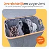 A top-down view of a grey fabric laundry sorter with three compartments, each containing laundry items. The lid is open, revealing the interior. Produktbild-Vorschau