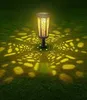 A solar-powered garden light casting decorative patterns on the grass at night. Produktbild-Vorschau