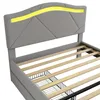 A close-up view of a gray upholstered bed frame with a slatted wooden base and integrated LED lighting. Anteprima dell’immagine prodotto