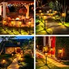 Collage of four images showing solar pathway lights in various outdoor settings at night. Anteprima dell’immagine prodotto