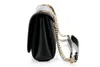 A black Guess handbag with a gold chain strap is shown from the side against a white background. Produktbild-Vorschau