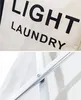 A close-up view of a laundry basket with text and a metal frame. Anteprima dell’immagine prodotto