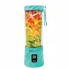 A mint green portable blender filled with sliced citrus fruits. Náhľad obrázku produktu