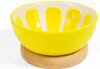 A yellow ceramic bowl with a lemon slice design inside, resting on a wooden base. Produktbild-Vorschau