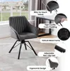 A grey velvet chair with black metal legs is shown in a room with a window and a desk. Produktbild-Vorschau