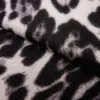 A close-up view of a fabric with a leopard print pattern. Produktbild-Vorschau