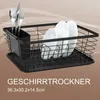 A black wire dish rack with plates and cutlery is shown on a tray. Produktbild-Vorschau