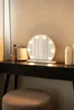 A vanity table with a Hollywood-style mirror, a stool, and various cosmetic items. Podgląd zdjęcia produktu