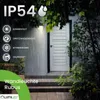 A wall-mounted outdoor light fixture is shown on a house exterior during a rain shower, with text overlays highlighting its features. Podgląd zdjęcia produktu