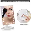 A split image showing a makeup mirror with LED lights and a woman applying makeup on the left, and a close-up of a finger touching the mirror's switch on the right. Produktbild-Vorschau
