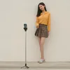 A young woman is posing for a photo taken by a selfie stick. Voir les images du produit