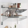 A stainless steel wall shelf with two tiers, holding jars, cups, and plates. Anteprima dell’immagine prodotto