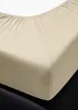 A close-up view of a beige fitted sheet on a dark surface. Produktbild-Vorschau
