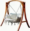 A wooden framed hanging chair with white cushions and macrame detailing, set against a white background. Produktbild-Vorschau