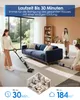 People using a wet dry vacuum cleaner in a modern living room with a sofa and large windows. Produktbild-Vorschau