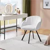A white vanity chair is placed in front of a white vanity desk with a lighted mirror and makeup accessories. Produktbild-Vorschau