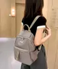 A person wearing a backpack in an indoor setting. Podgląd zdjęcia produktu