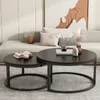 Two round coffee tables are placed in a living room setting, with a sofa and artwork in the background. Náhľad obrázku produktu
