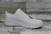 A white Skechers shoe is shown from the side against a wooden plank background. Produktbild-Vorschau