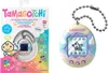 A Tamagotchi toy and its packaging are displayed side-by-side. Produktbild-Vorschau