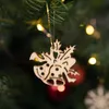 A wooden Christmas tree ornament hangs on a branch of a Christmas tree, with blurred lights in the background. Produktbild-Vorschau