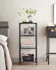 A shelf unit with decorative items next to a bed and a vanity table. Produktbild-Vorschau