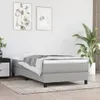 A bed frame with a mattress and bedding in a room with artwork and a plant. Podgląd zdjęcia produktu