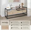 A sideboard with a glass top and wooden drawers, displayed in a room setting with decorative items. Produktbild-Vorschau