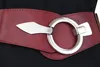 Close-up of a red elastic belt with a silver ring buckle. Produktbild-Vorschau