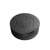 A black, circular electronic device with a logo on top and a USB-C port on the side, isolated on a white background. Produktbild-Vorschau