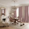 A dining room with a round table, chairs, a fireplace, and curtains. Voir les images du produit