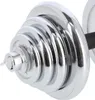 A close-up view of a chrome dumbbell with multiple weight plates stacked on its end. Náhled obrázku produktu