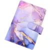 A close-up, angled view of a binder notebook with a marble-like pattern in shades of purple, pink, and blue, accented with gold veins. It has a strap closure with a button. The background is plain white. Voir les images du produit