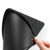 A hand is shown holding the edge of a black tablet case with a carbon fiber texture. Produktbild-Vorschau