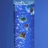 A bubble column with several small, colorful fish inside, illuminated by blue light. Produktbild-Vorschau