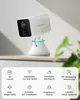 A white security camera on a white stand, displayed on a shelf with a blurred green plant in the background. The bottom of the image features a grid of icons and text describing the camera's features. Produktbild-Vorschau