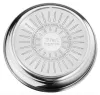 The bottom of a stainless steel wok pan with embossed text and radial lines. Voir les images du produit
